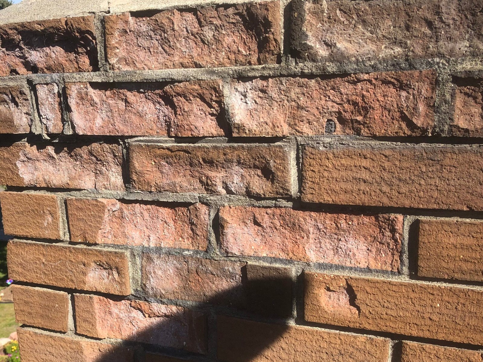 Spalling damage of bricks caused by water running down the surface of the chimney