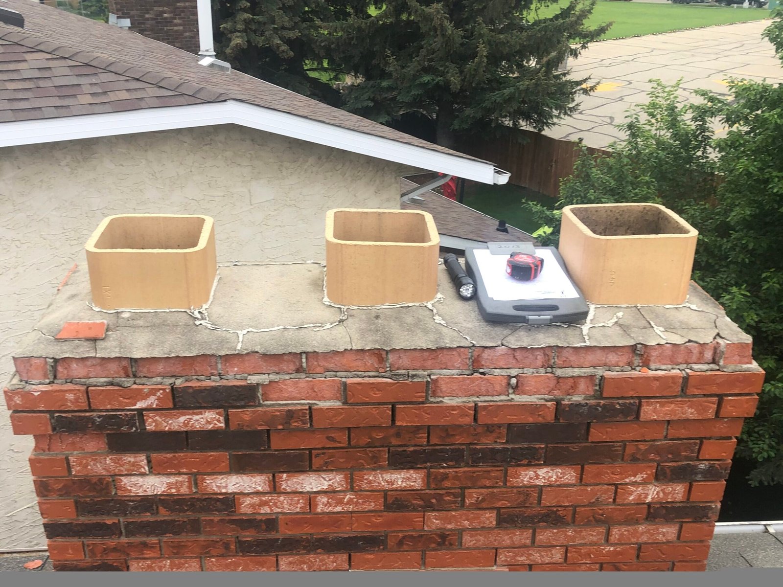 Chimney crown is cracked and does not project past the surface of the chimney adequately to protect the chimney from freeze thaw cycles and water intrusion.