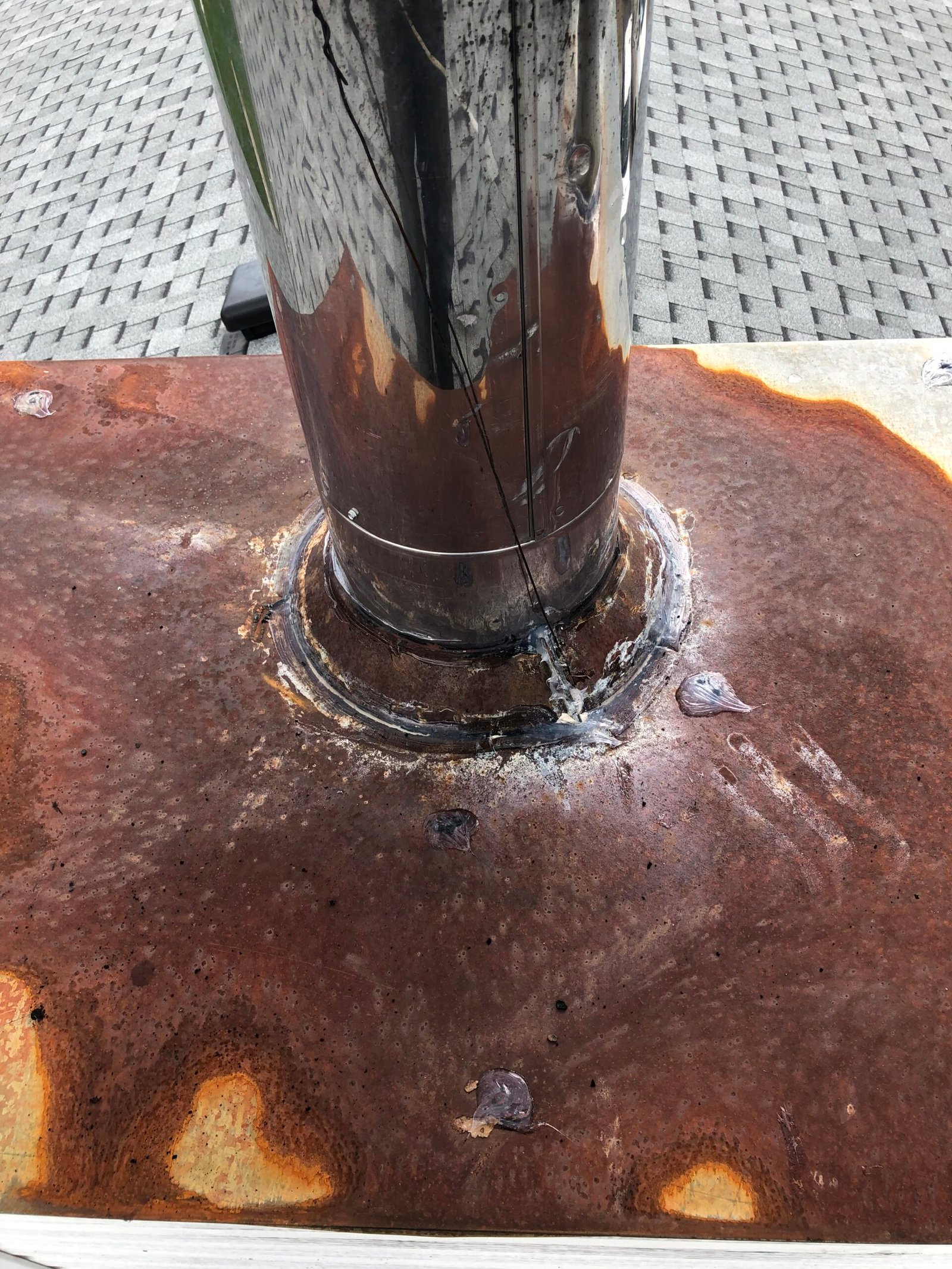 Severe corrosion on factory fireplace chase cap. may result in water damage within the house structure.