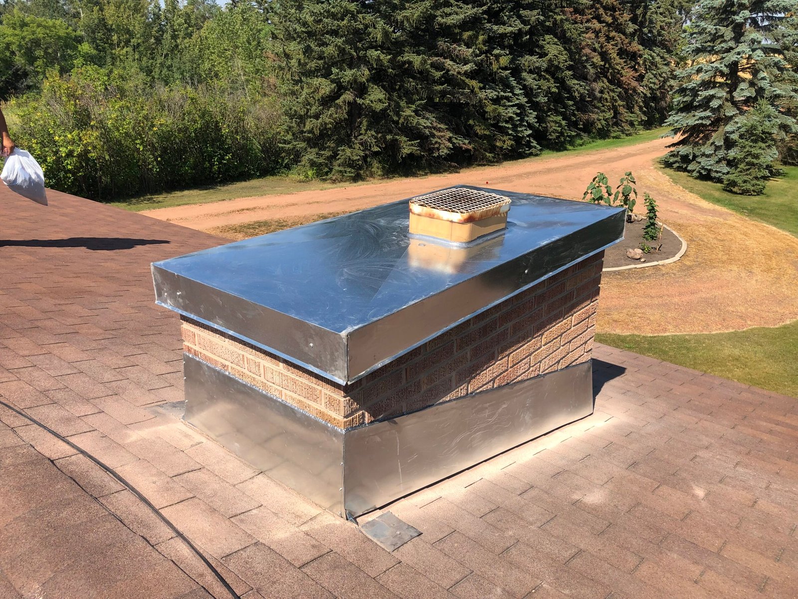 Masonry chimney repair on existing masonry fireplace. New metal crown sheds water off the brick. the absence of flashing was repaired by installing a new flashing set into the chimney.